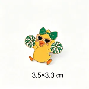 Detail of cheerleader duck enamel pin measuring 3.5 x 3.3 cm size