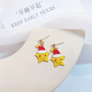 Detailed view of cute cartoon Christmas star earrings with Santa hats and 925 silver pins