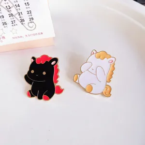 Close-up of cute horse enamel pins in black and white for Year of the Horse