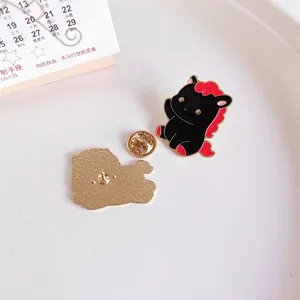 Close-up detail of cute black and red horse enamel pin showing both front and back view