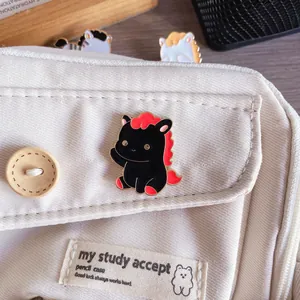 Detailed view of a cute black horse enamel pin pinned on a white canvas pencil case