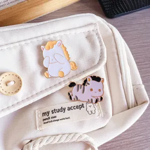 Close-up of two cute enamel pony pins on a canvas bag for the 2026 Year of the Horse