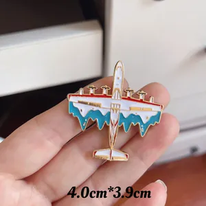 Detailed macro view of white and blue military aircraft enamel pin badge in hand