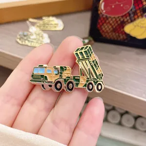 Macro view of a DF-41 intercontinental missile launcher enamel pin badge held in hand.