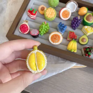 Close-up detail of realistic resin durian fruit pin with vibrant yellow texture.