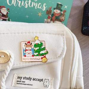 Macro view of cute Christmas reindeer and tree metal enamel pin on white canvas bag