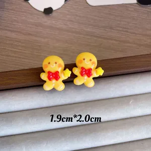 Macro detail of cute yellow gingerbread man Christmas earrings with size dimensions
