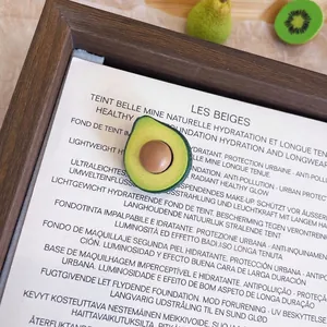 Macro detail of a realistic resin avocado brooch with dimensions 1.5cm by 2.3cm.