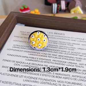 Detailed macro view of a handmade passion fruit resin brooch pin measuring 1.3x1.9cm
