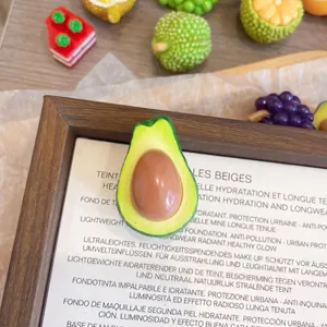 Close-up of cute 3D resin avocado fruit brooch showing size: 2.3cm x 3.4cm