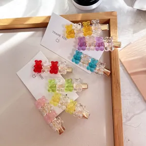 Detail shot of cute transparent candy-colored gummy bear hair clips for girls.