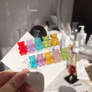 Close-up of colorful transparent gummy bear hair clips on a white display card.