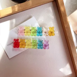 Transparent gummy bear hair clips in vibrant candy colors displayed on wooden tray