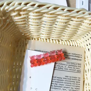 Detailed close-up of cute glitter resin bear hair clip with dual pink and orange colors