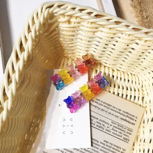 Detailed shot of cute colorful gummy bear hair clips with glitter inside a basket