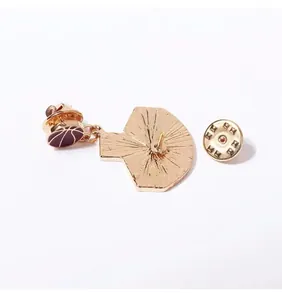 Detail view of the metal sports pin back showing the butterfly clutch and gold finish.