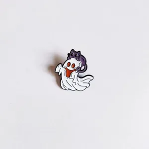 Close-up of a cute Halloween enamel pin featuring a cartoon ghost with a purple cat.