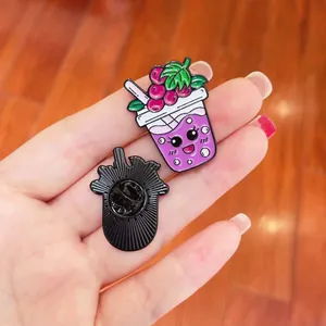Detailed view of a cute cartoon grape milk tea enamel pin with its black metal back.