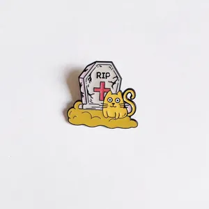 Detailed macro view of a cute Halloween cartoon cat and tombstone enamel pin badge