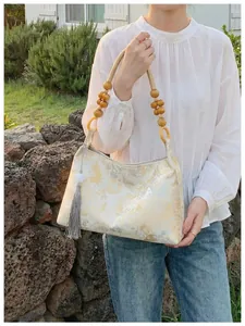 Elegant New Chinese style underarm bag featuring gold floral pattern and wooden bead strap