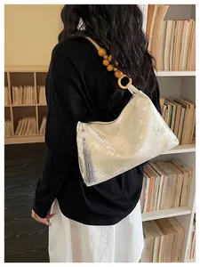 Detail of New Chinese style hobo bag featuring floral jacquard and wooden bead strap