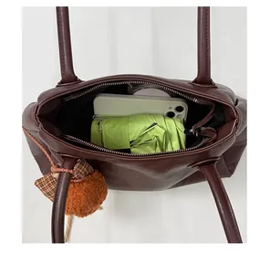 Large capacity interior of a retro brown tote bag with phone and umbrella props