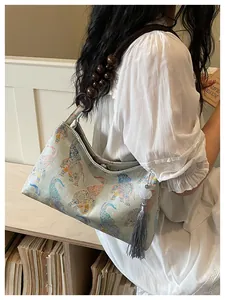 Close-up of new Chinese style underarm bag with elephant pattern and wooden bead strap