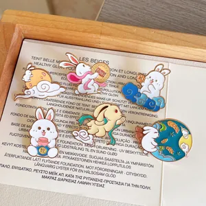 Close-up detail of cute Mid-Autumn Festival rabbit enamel pins on a decorative card.