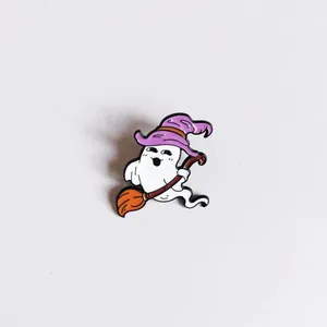 Detail of cute Halloween ghost enamel pin riding a broomstick with witch hat