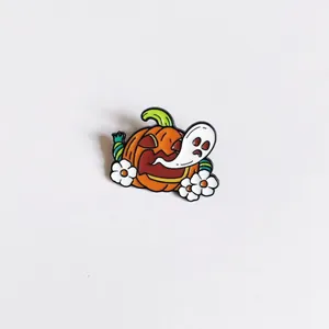 Detailed close-up of a cute Halloween enamel pin featuring a pumpkin and ghost