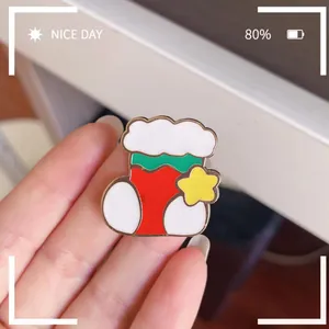 Close-up macro detail of a colorful Christmas stocking enamel pin badge with star