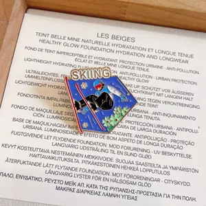 Macro view of creative blue enamel skiing pin featuring a skier athlete design and text
