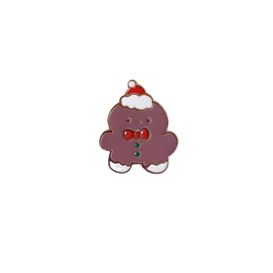 Cute cartoon gingerbread man enamel brooch pin featuring a festive red Christmas hat