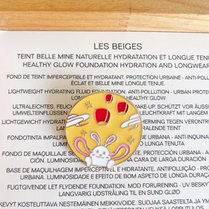 Close-up detail of a cute rabbit enamel brooch with red lanterns on a yellow background