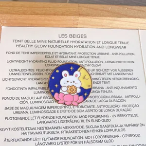 Detailed view of a cute cartoon rabbit enamel pin with a moon and lotus design.