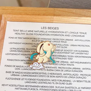 Detailed macro shot of an elegant Chinese-style rabbit enamel pin on a white cloud