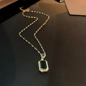 Elegant emerald green rectangular pendant necklace with gold chain and crystal accents
