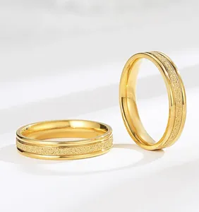 Close-up detail of a gold-plated titanium steel ring featuring a textured frosted center band