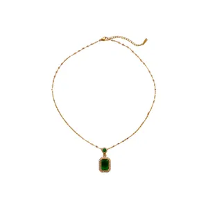 Elegant emerald green gemstone necklace with a gold chain and a halo pendant for women