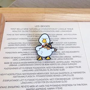 Detailed macro shot of a cute cartoon white duck playing the violin enamel metal pin
