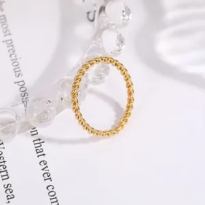 Detailed view of a minimalist gold titanium steel twisted rope ring for women