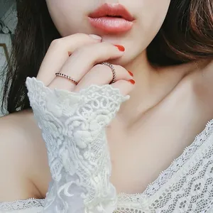 Close-up of minimalist rose gold twisted titanium steel rings worn by a model