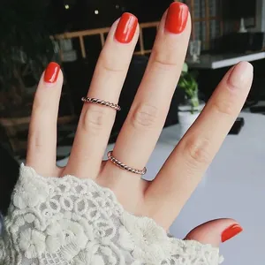Rose gold titanium steel twisted rings set worn on female hand with lace sleeve