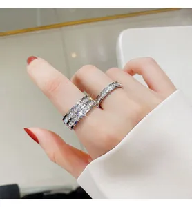 Close-up of sparkling pavé set eternity rings in silver finish on a female hand
