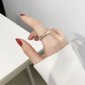 Detailed close-up of a sparkling full diamond pavé titanium steel ring on finger