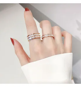 Elegant rose gold titanium steel rings featuring full diamond rows shown on a lady's finger
