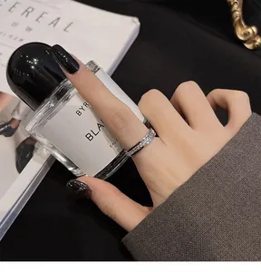 Detailed view of a minimalist stainless steel ring with full diamond stones on hand.