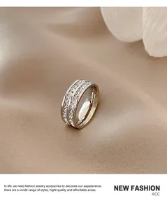 Detail view of a sparkling titanium steel ring with pavé stones on silk fabric