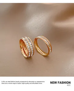 Close-up of sparkling full diamond stainless steel rings on brown fabric