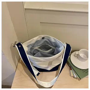 Interior view of contrast canvas tote bag with striped lining and multiple pockets